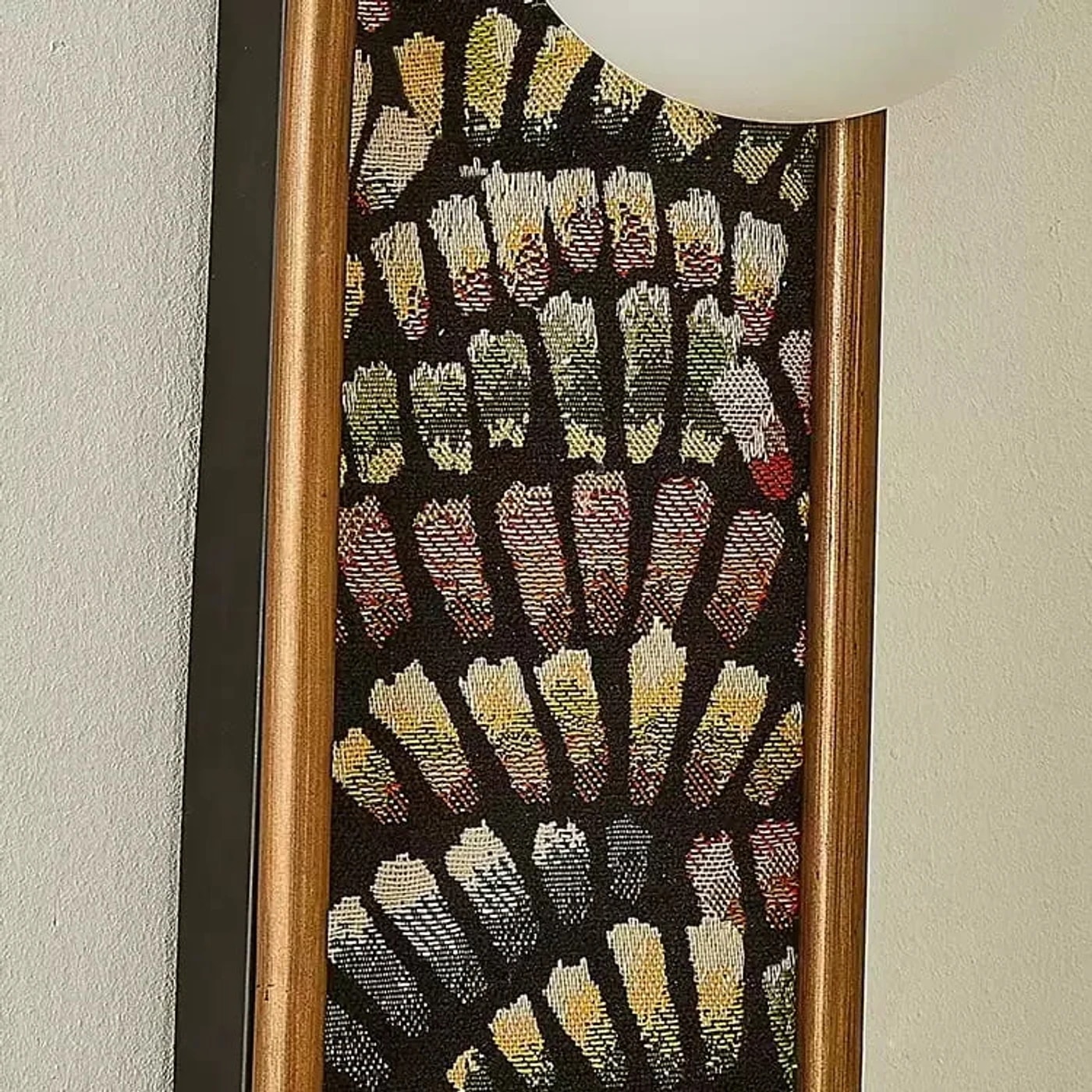 Close detail of fabric panel and warm metal edge