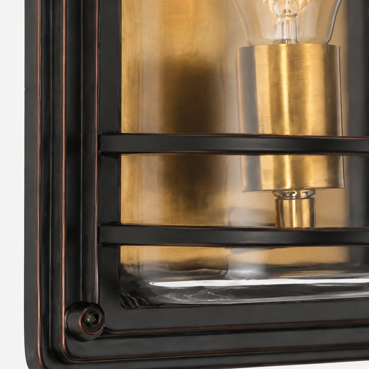 Close view of bronze cage frame and clear glass shade