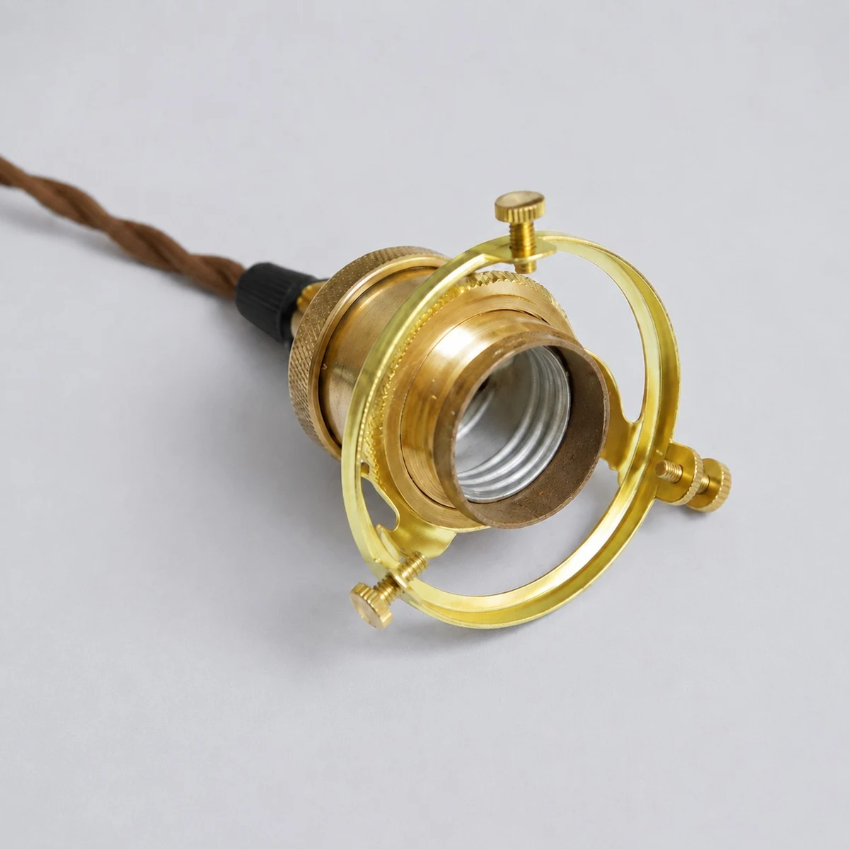 Antique brass socket detail on a gray background