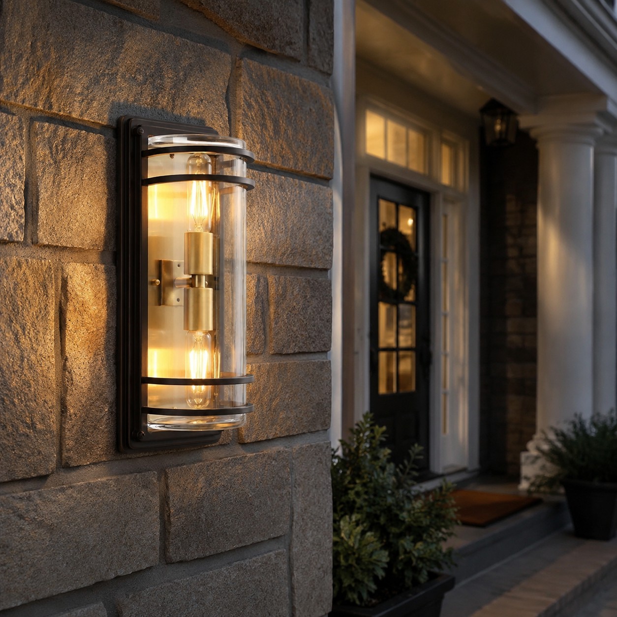 Medium bronze glass wall sconce on a stone exterior wall