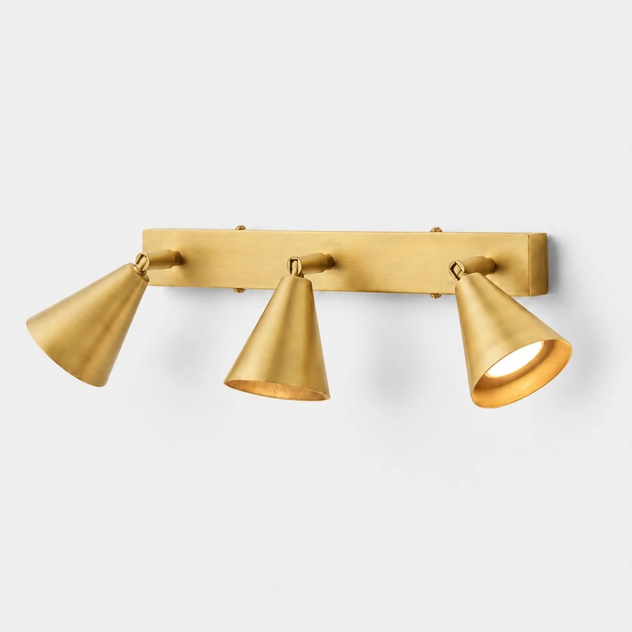 Three-head brass adjustable cone wall lamp on linear backplate