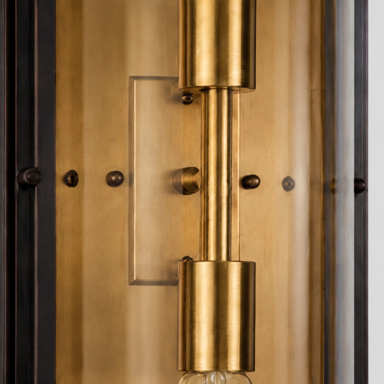 Close view of brass bulb holder inside the glass wall sconce